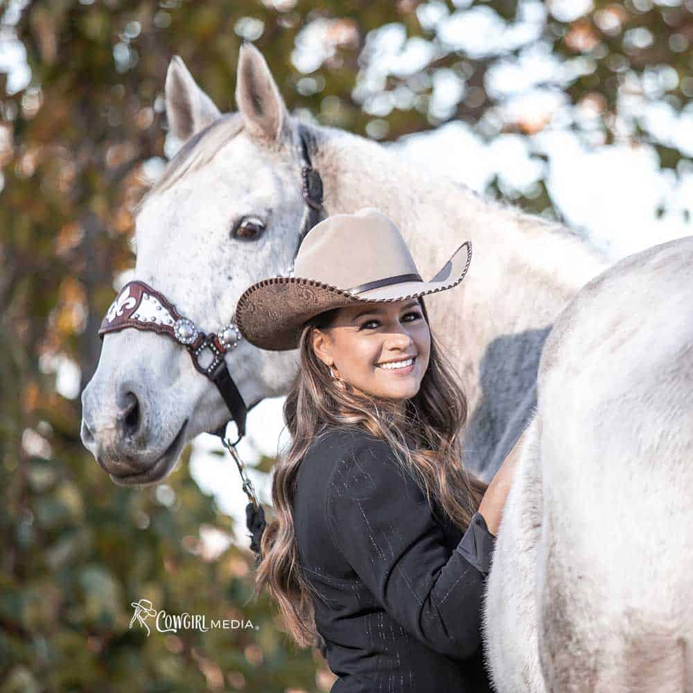 Cowgirl posing with horse