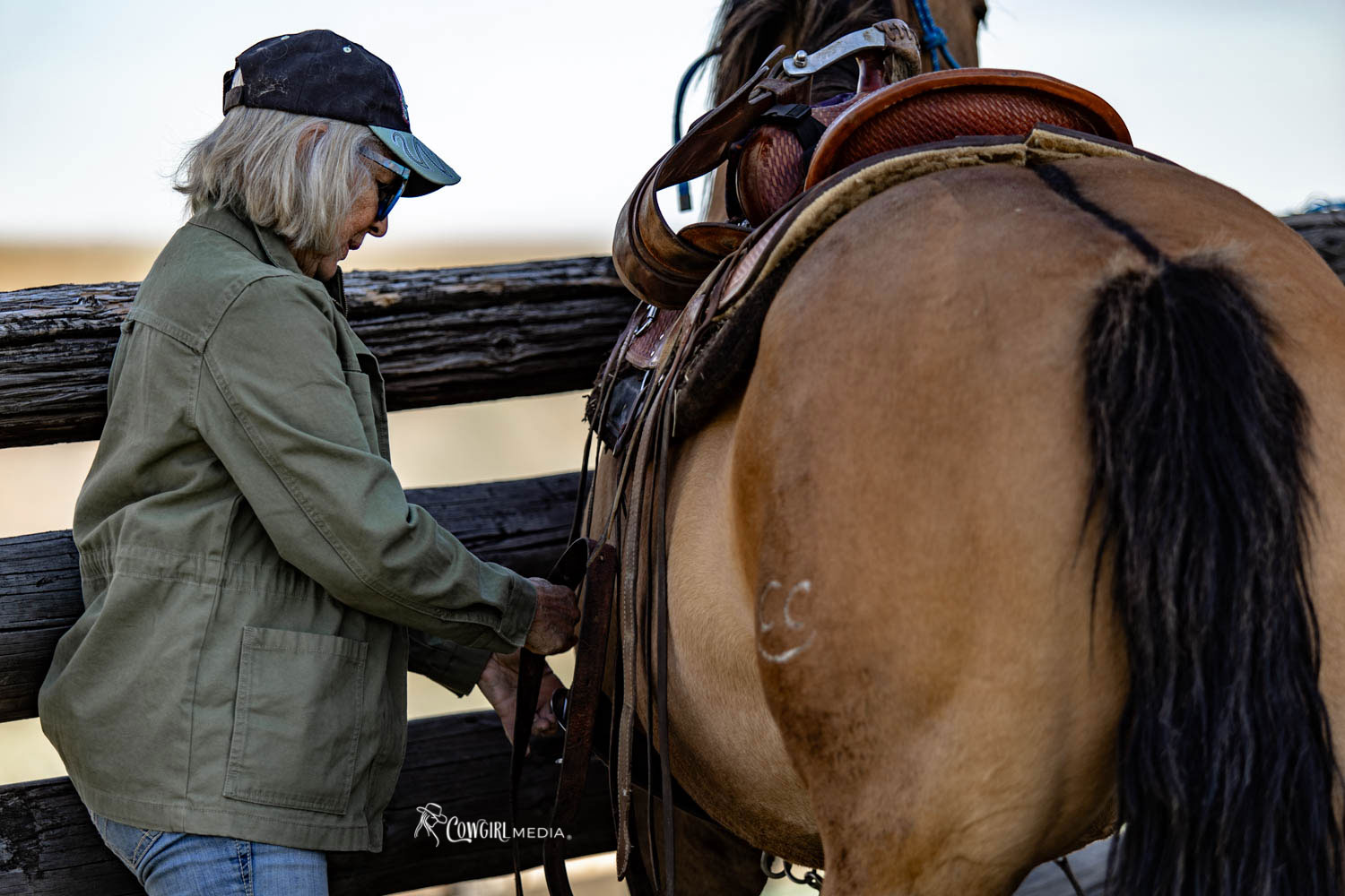 woman saddling her horse