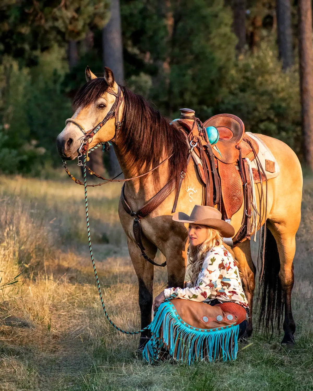 Theresa squatting down next to her buckskin Morgan gelding Rio