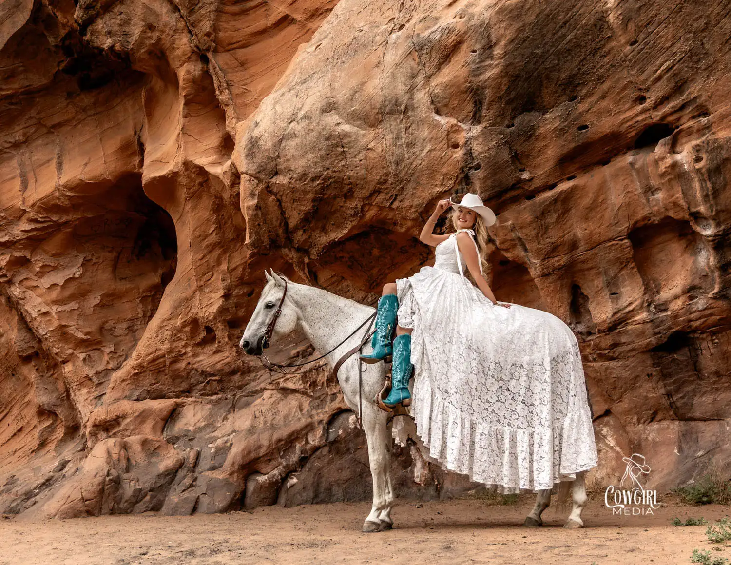 Miss Rodeo Ogden, Miriam Brophy, posing in Red Ledges Park in a flowy white dress, turquoise boots and her AQHA gelding